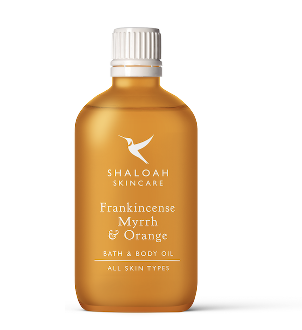 Orange body oil in decorative bottle