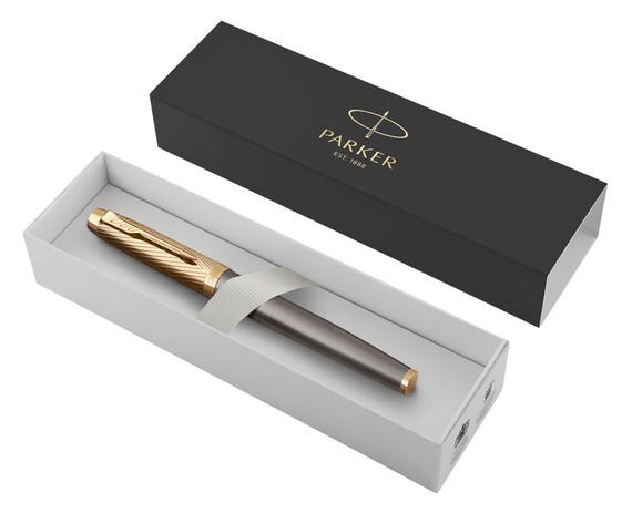 Gold and grey fountain pen in parker branded black presentation box.