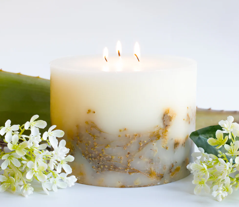 3 wick botanical candle with florals displayed alongside