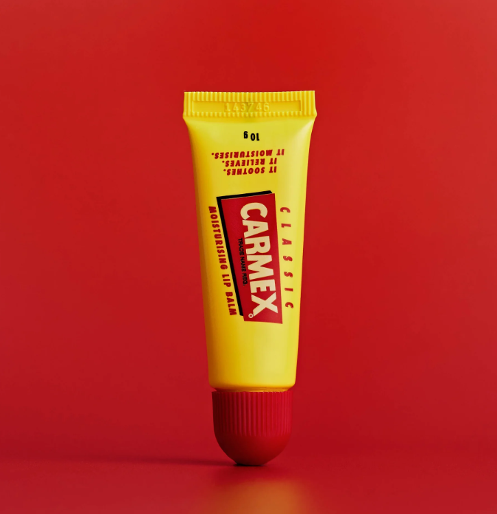 Carmex tube on red backdrop