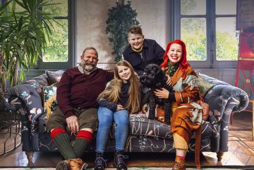 the strawbridge family pose on their sofa