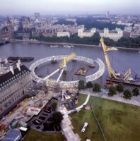 Image of the London Eye from above with the river behind it.