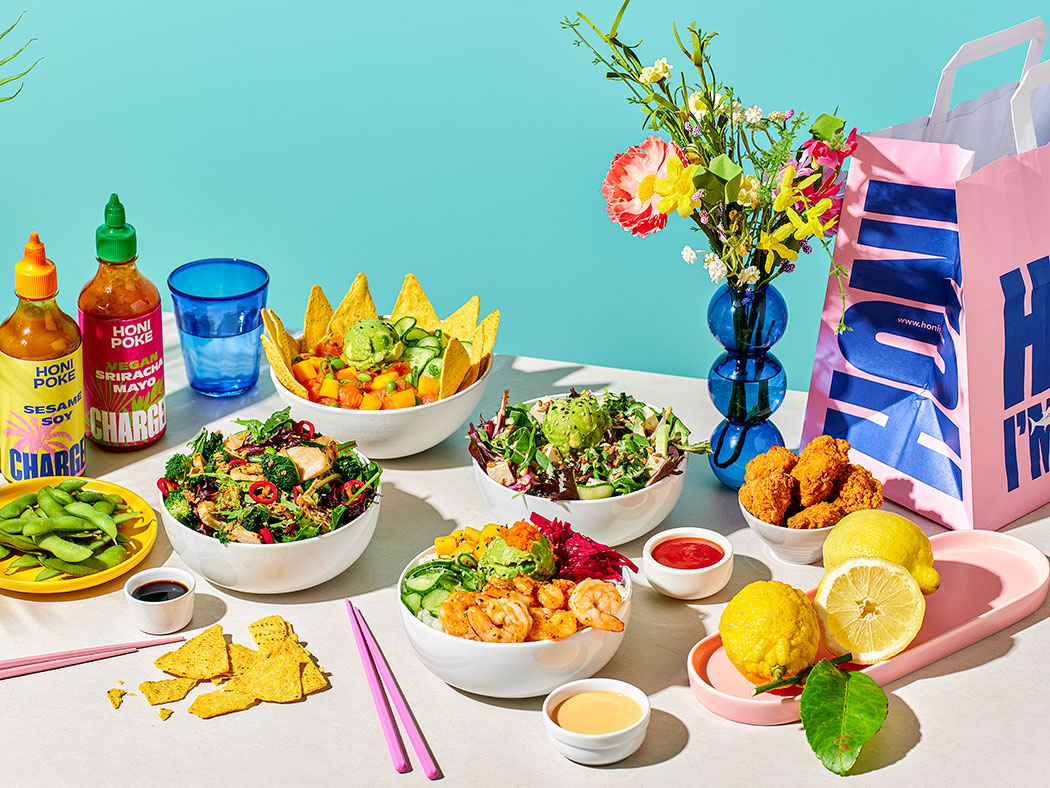Honi Poke menu on white table with bright accessories